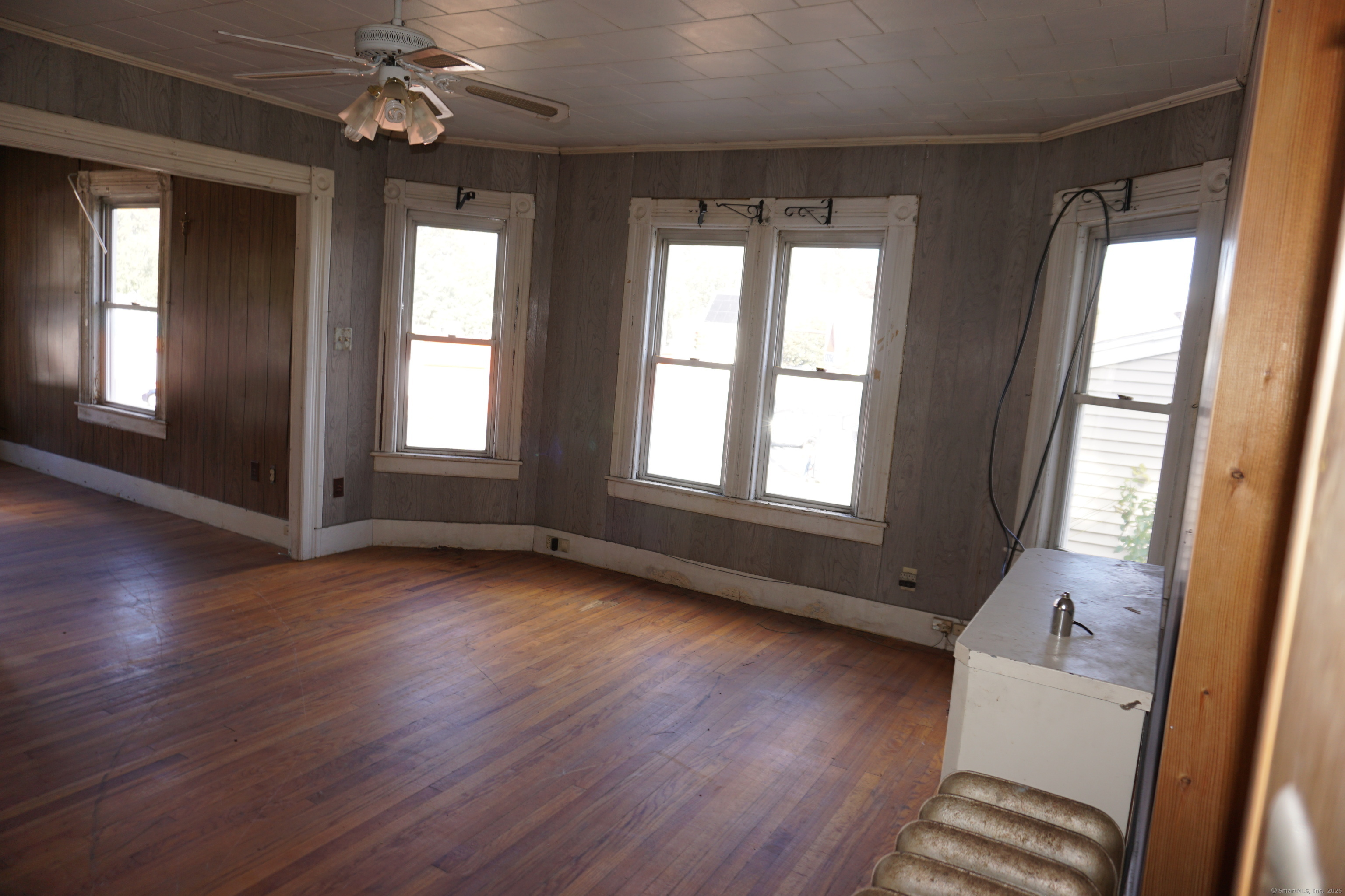 327 Orange Street Springfield, MA 01108 - Photo 31 of 32 a view of an empty room with wooden floor and a window