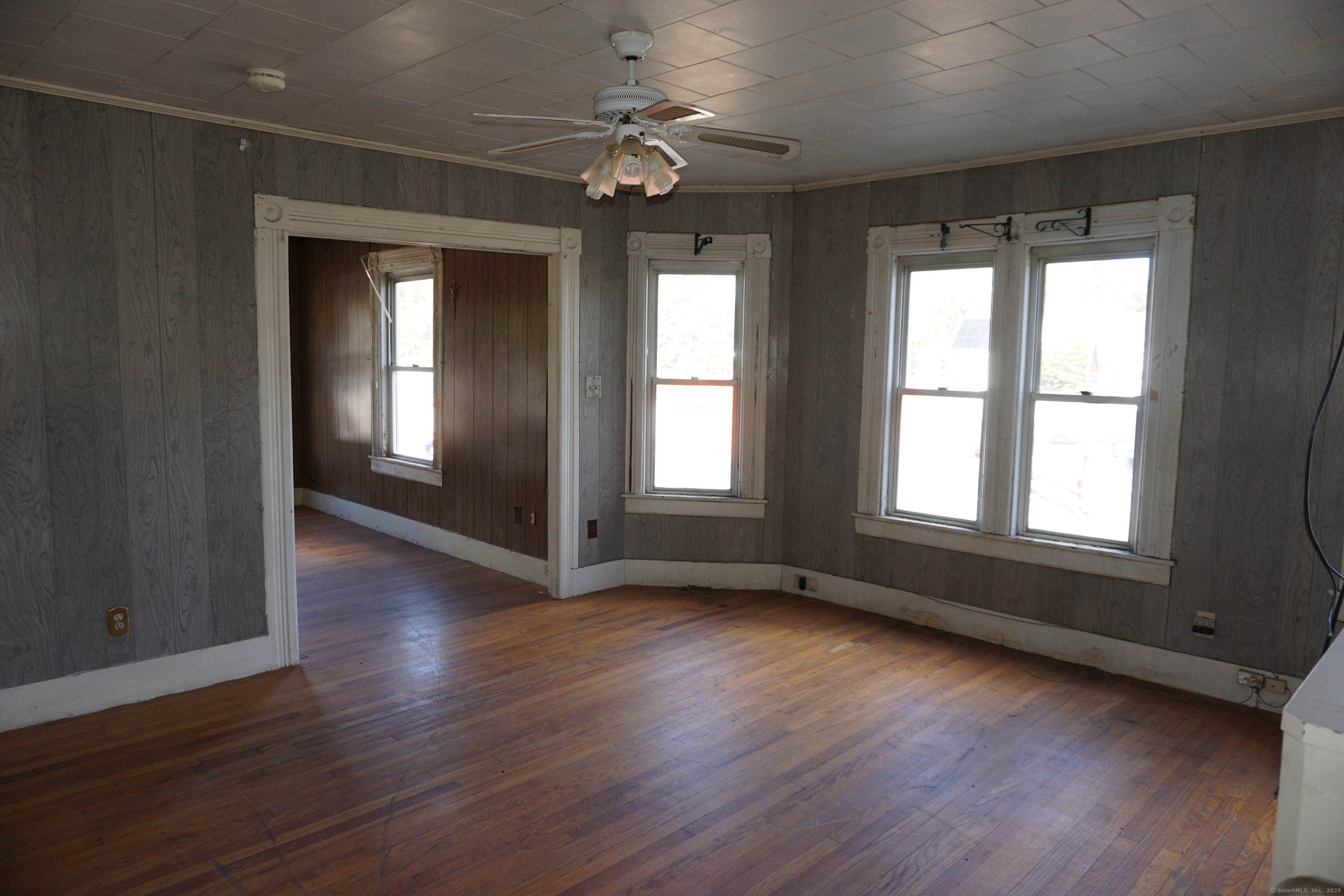 327 Orange Street Springfield, MA 01108 - Photo 32 of 32 a view of an empty room with wooden floor and a window