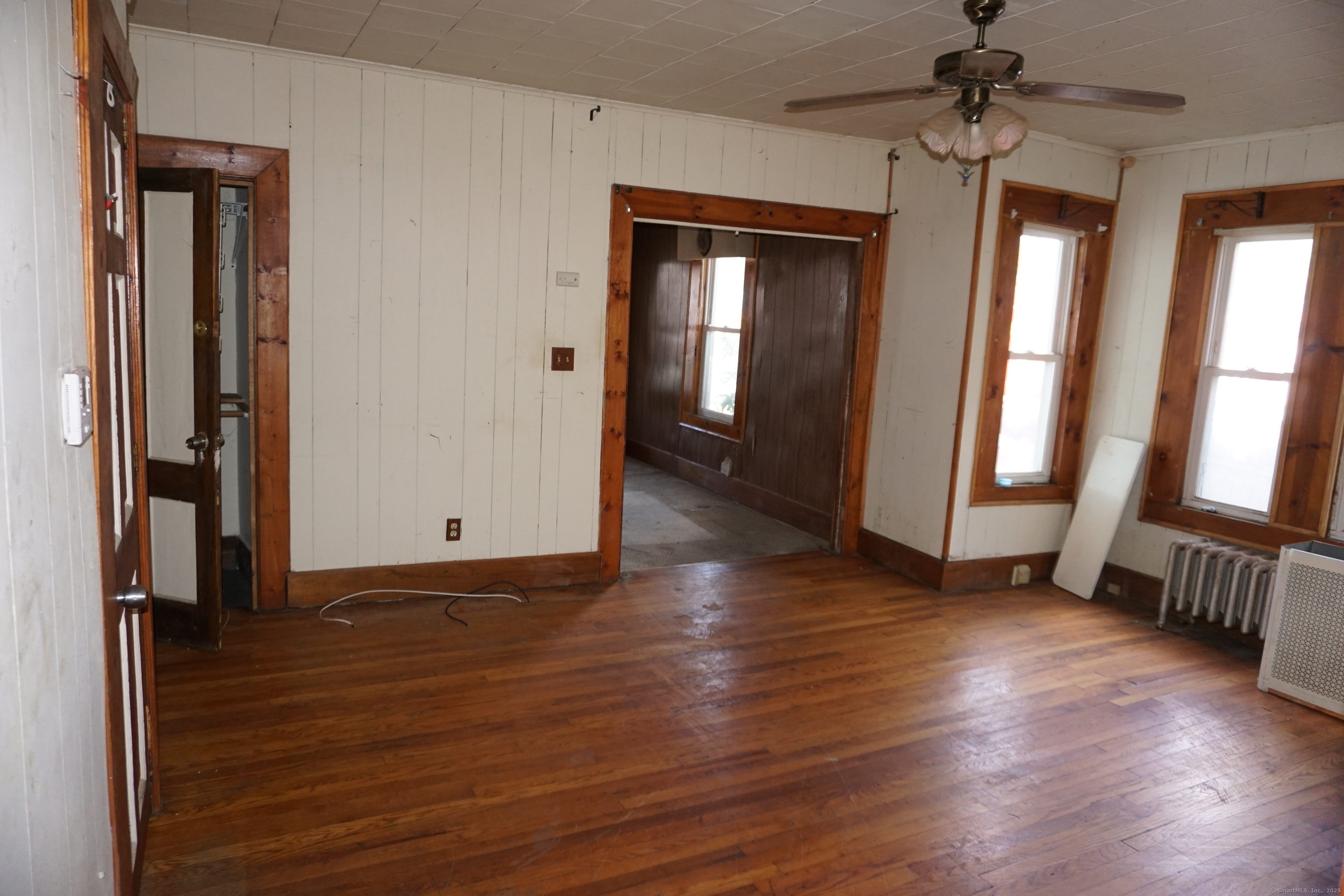 327 Orange Street Springfield, MA 01108 - Photo 6 of 32 an empty room with wooden floor and windows