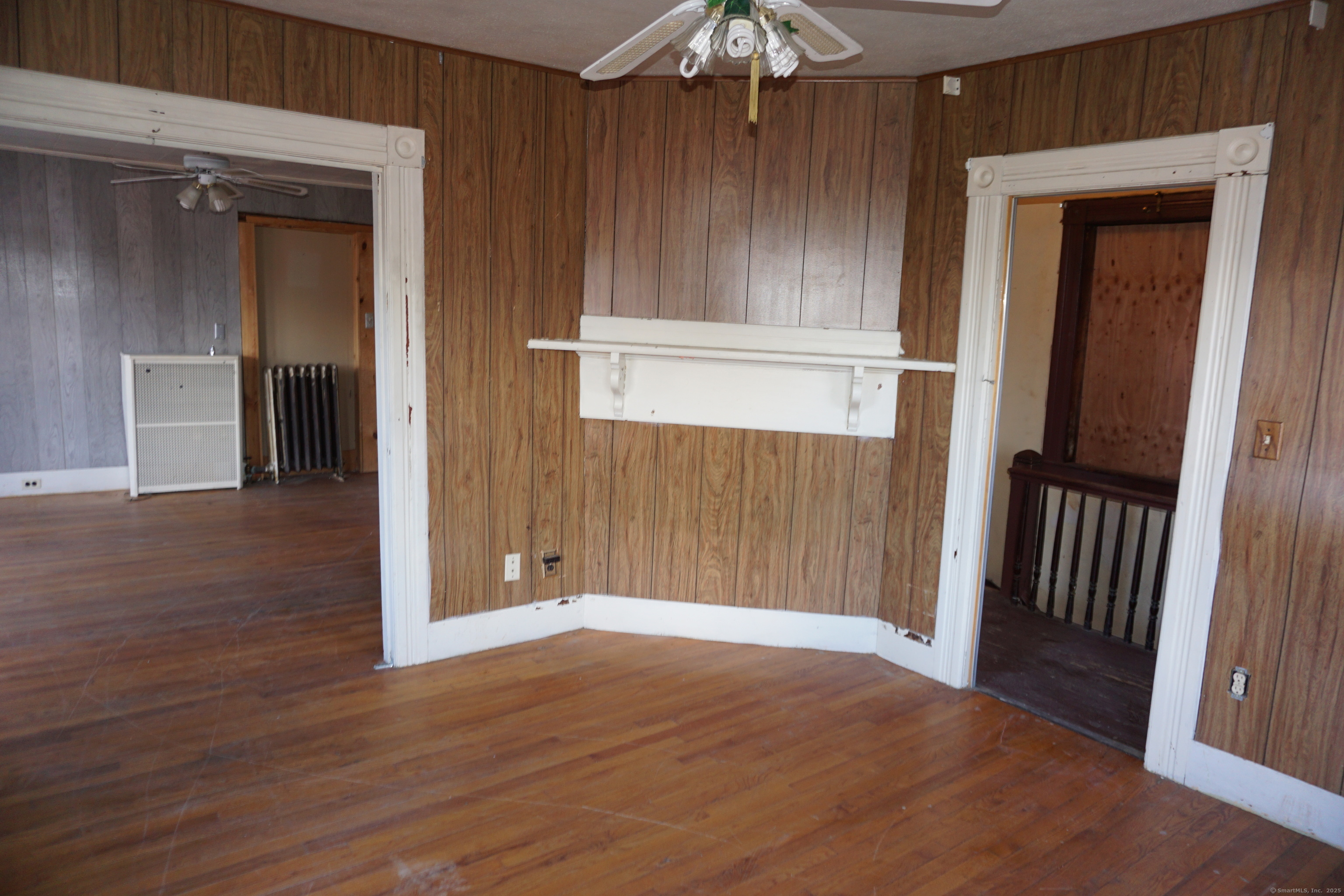 327 Orange Street Springfield, MA 01108 - Photo 10 of 32 an empty room with wooden floor fan and windows