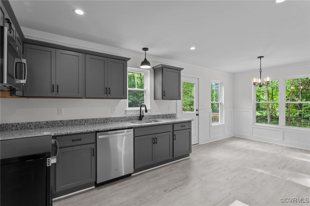 726 Stoney Point Road Cumberland, VA 23040 - Photo 6 of 32 a large kitchen with kitchen island granite countertop a sink window and cabinets