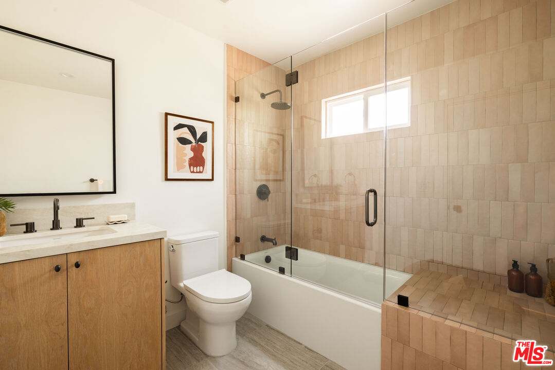 1016 Manzanita Street Los Angeles, CA 90029 - Photo 18 of 35 a bathroom with a toilet a sink and bathtub