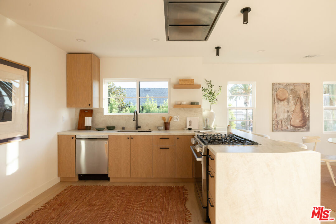 1016 Manzanita Street Los Angeles, CA 90029 - Photo 9 of 35 a kitchen with a sink stove and cabinets