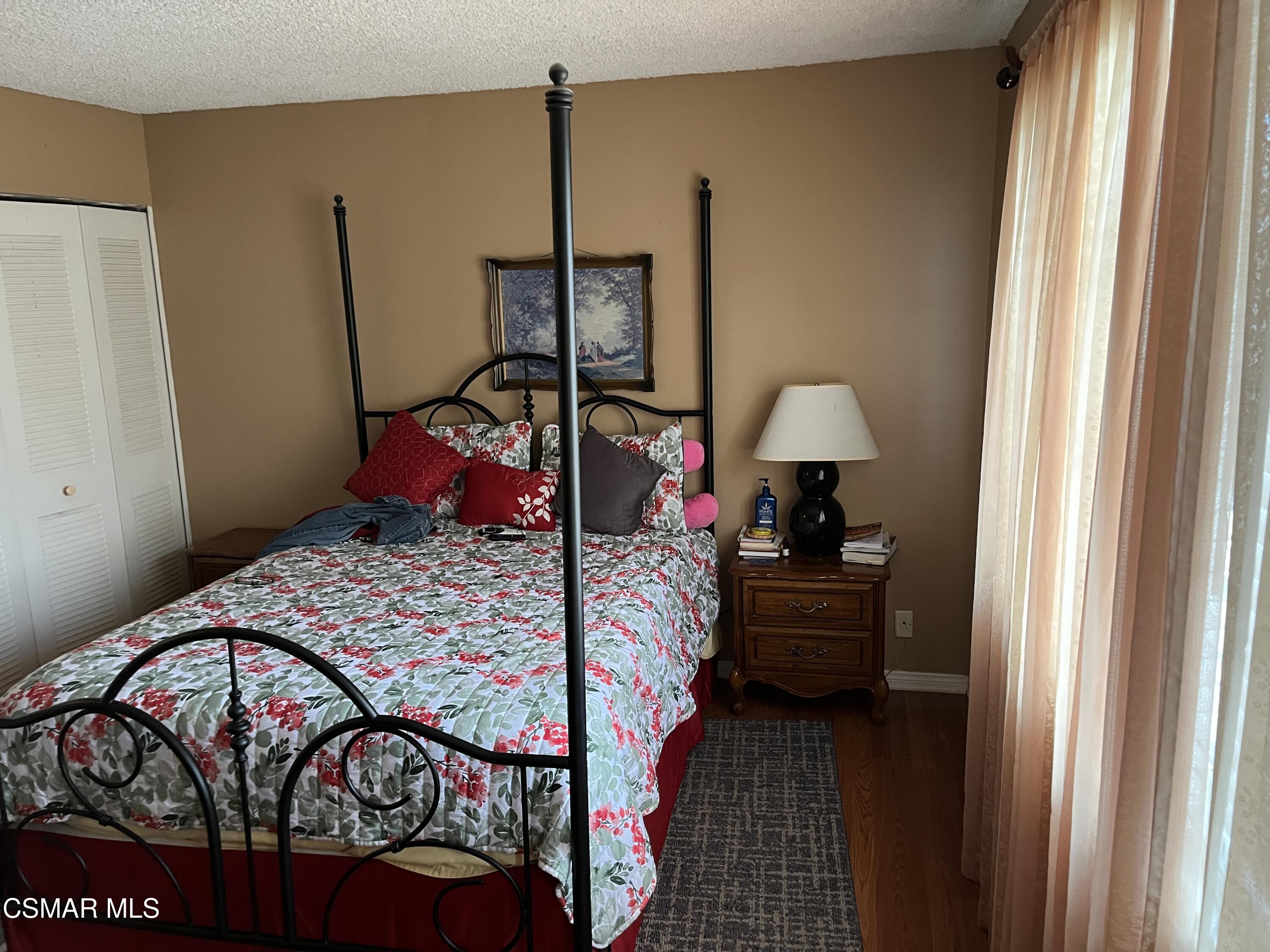 2161 Lysander Avenue Simi Valley, CA 93065 - Photo 22 of 44 a bedroom with a bed window and a lamp on table