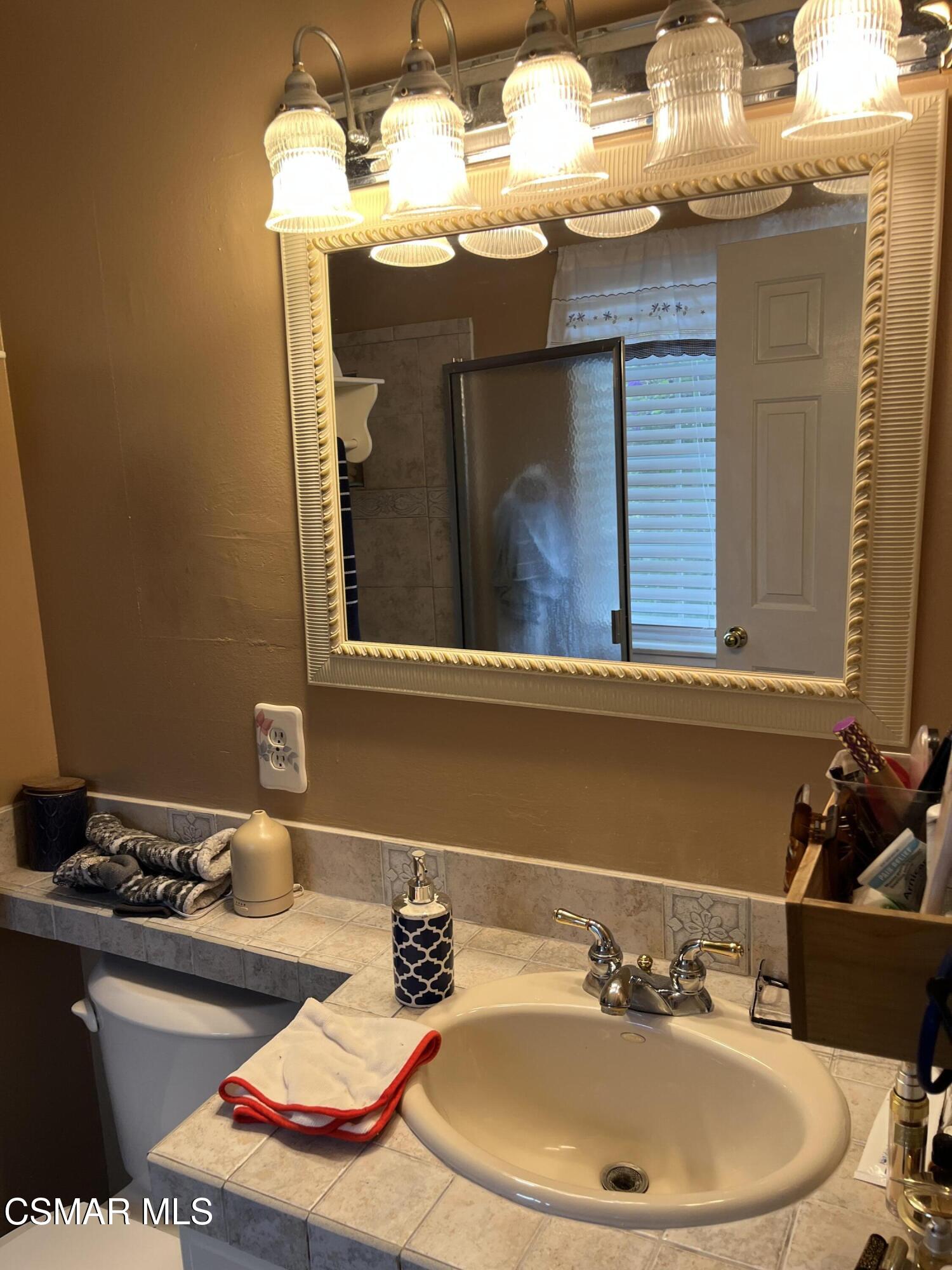 2161 Lysander Avenue Simi Valley, CA 93065 - Photo 32 of 44 a bathroom with a sink and a mirror