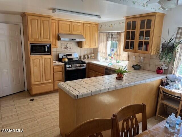 2161 Lysander Avenue Simi Valley, CA 93065 - Photo 6 of 44 a kitchen with granite countertop a sink stove and refrigerator