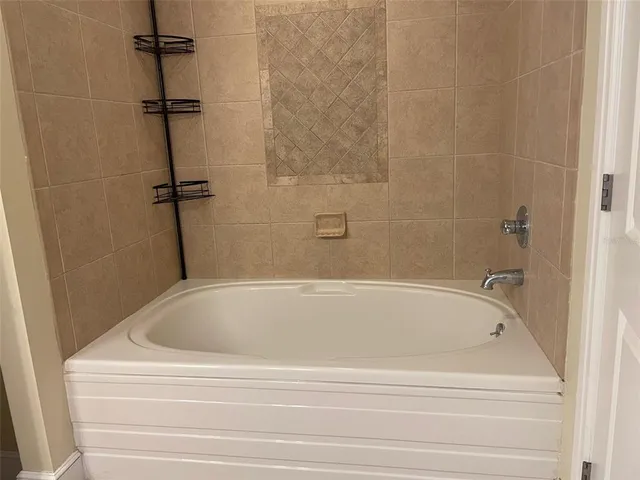 a bathroom with a granite countertop sink and a toilet