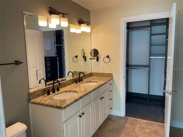 a bathroom with sinks granite and a vanity