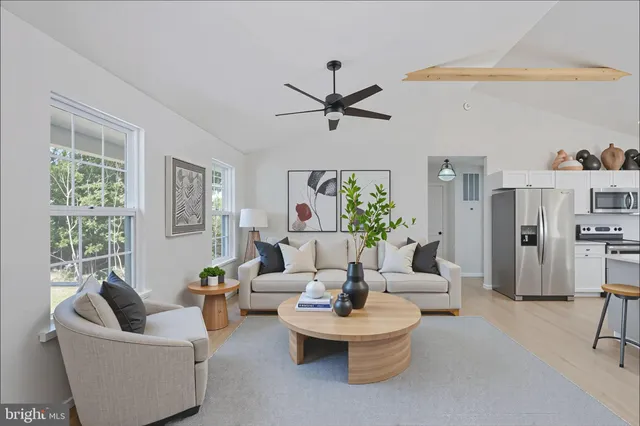 a kitchen with kitchen island a counter top space appliances and a sink