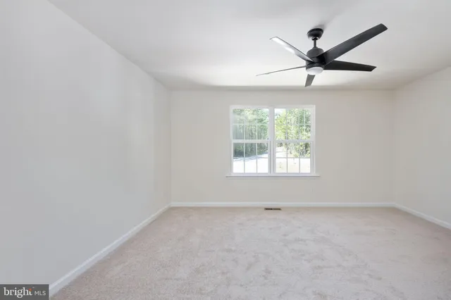 a bathroom with a tub a double vanity sink and a mirror