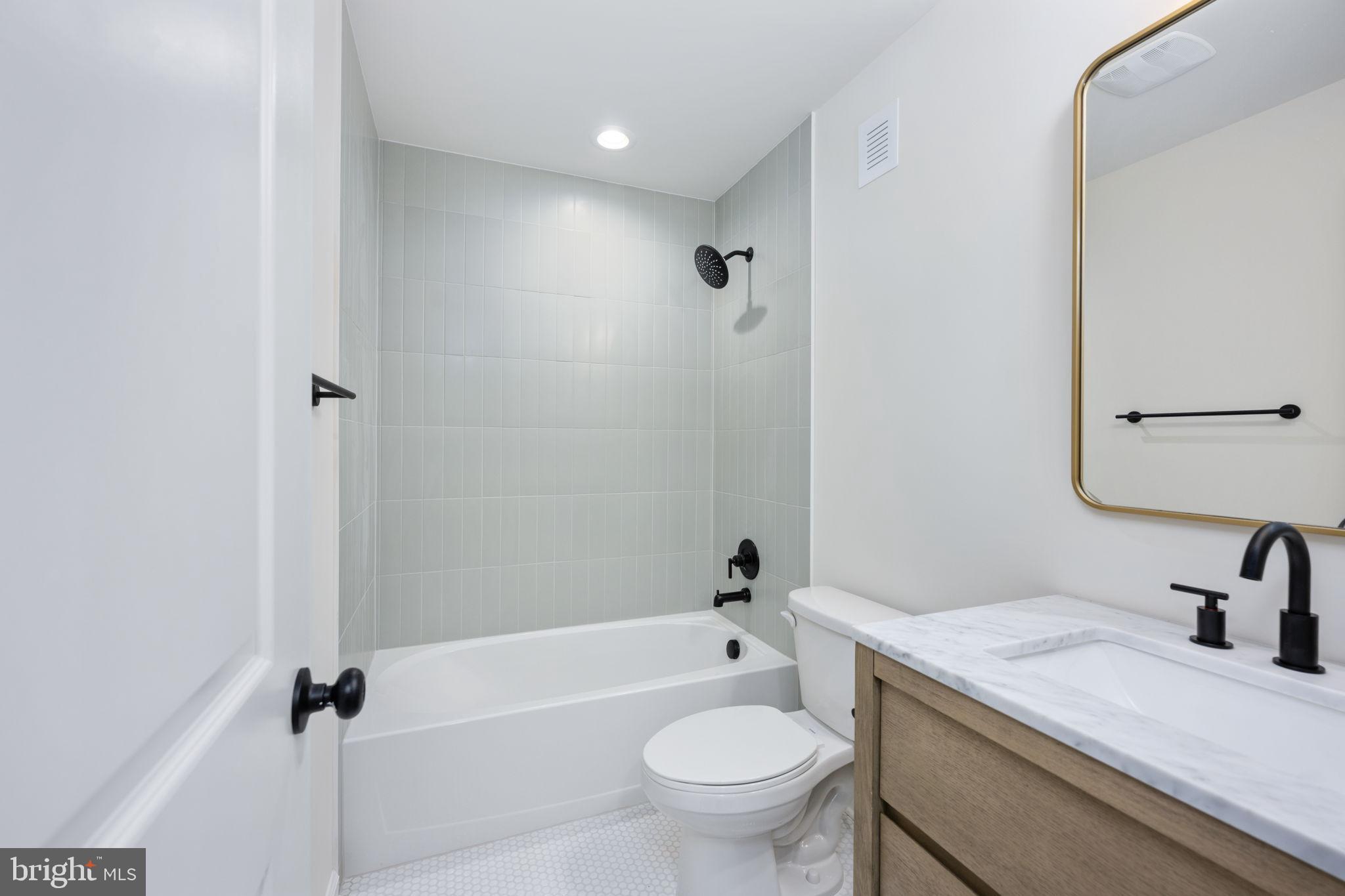 1829 Butler Road Beaverdam, VA 23015 - Photo 50 of 61 a bathroom with a granite countertop sink a toilet and a bathtub