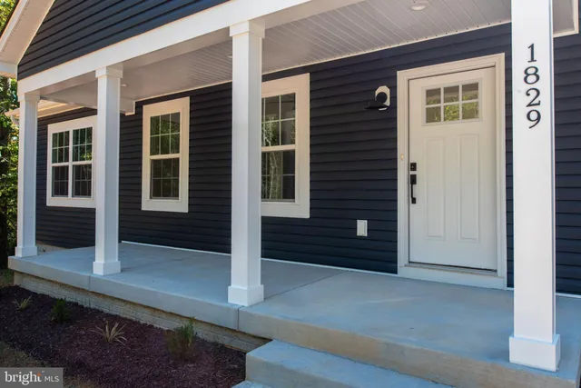 a view of a dining room with furniture and a chandelier
