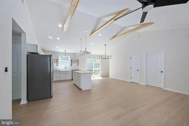 a kitchen with cabinets appliances and a window