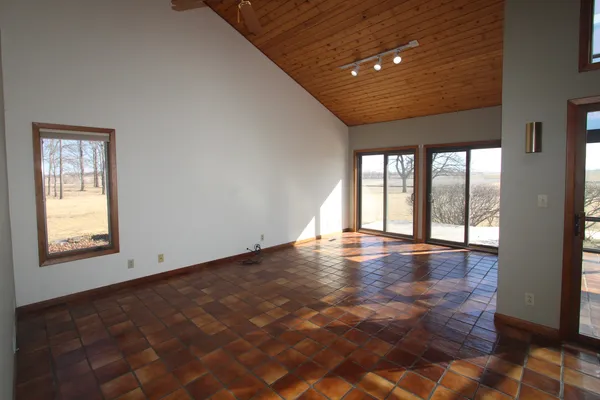 a view of empty room with wooden floor and fireplace