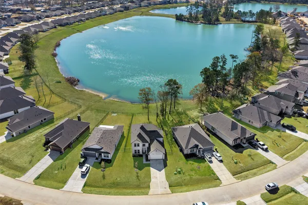 an aerial view of residential houses with outdoor space and swimming pool