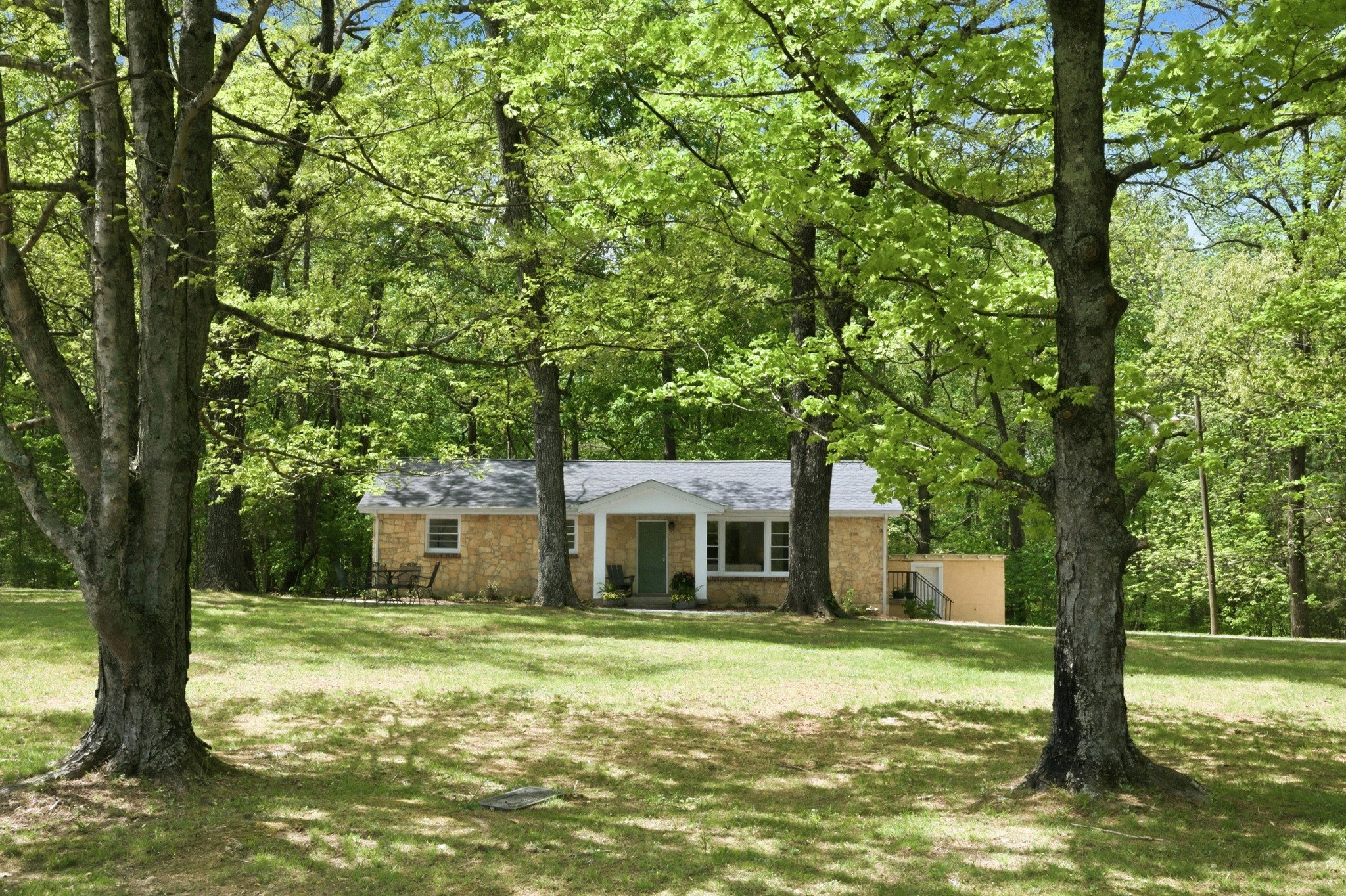 1566 Porter Road Burns, TN 37029 - Photo 3 of 41 a front view of a house with a garden