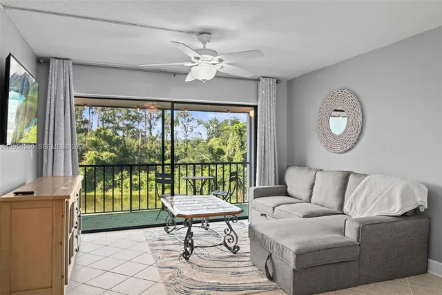 a view of a dining room with furniture a rug and wooden floor