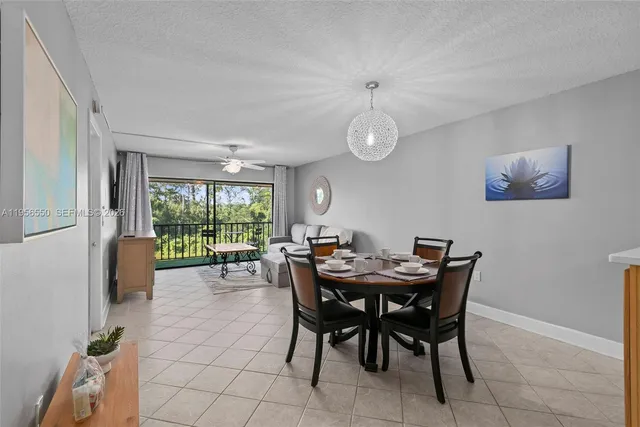 a view of a dining room and livingroom with furniture wooden floor and a rug