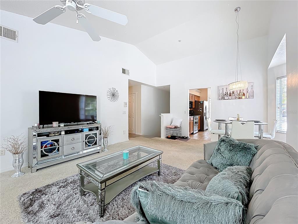 1050 Loch Vail, Unit 21 Apopka, FL 32712 - Photo 11 of 46 a living room with furniture and a flat screen tv