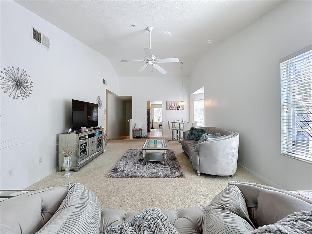 1050 Loch Vail, Unit 21 Apopka, FL 32712 - Photo 12 of 46 a living room with furniture and a flat screen tv