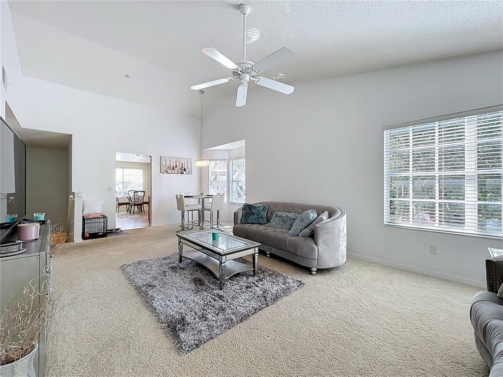 1050 Loch Vail, Unit 21 Apopka, FL 32712 - Photo 13 of 46 a living room with furniture and a large window