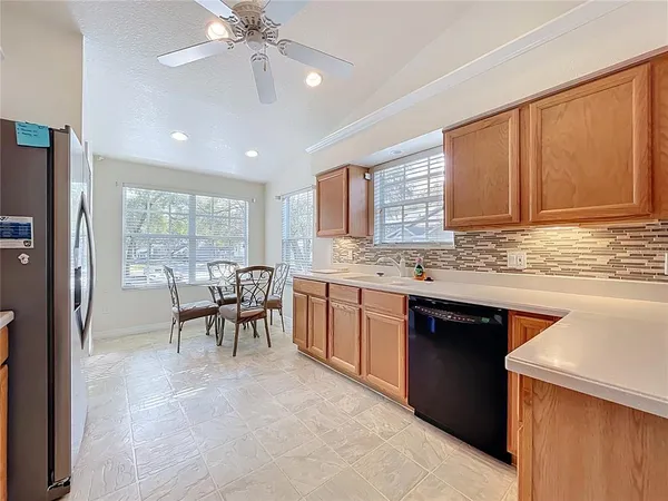 a kitchen with stainless steel appliances a sink stove and refrigerator