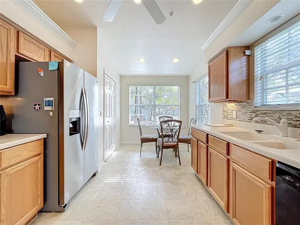 a kitchen with stainless steel appliances granite countertop a stove a refrigerator microwave a sink dishwasher and wooden cabinets