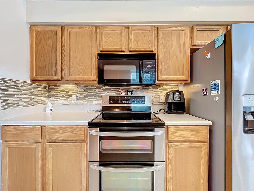 1050 Loch Vail, Unit 21 Apopka, FL 32712 - Photo 18 of 46 a kitchen with appliances a sink and cabinets