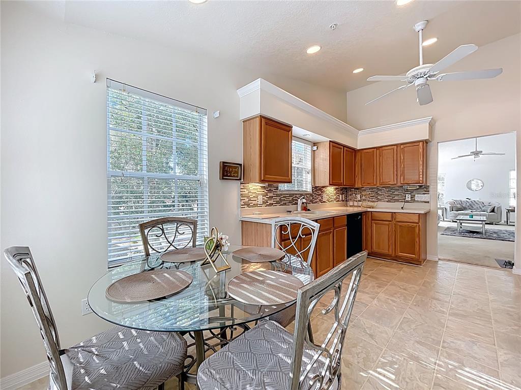 1050 Loch Vail, Unit 21 Apopka, FL 32712 - Photo 20 of 46 a kitchen with stainless steel appliances kitchen island granite countertop a sink a stove a kitchen island and chairs