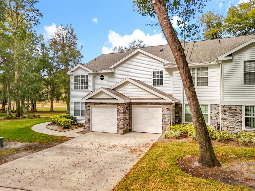 1050 Loch Vail, Unit 21 Apopka, FL 32712 - Photo 2 of 46 a front view of a house with a yard