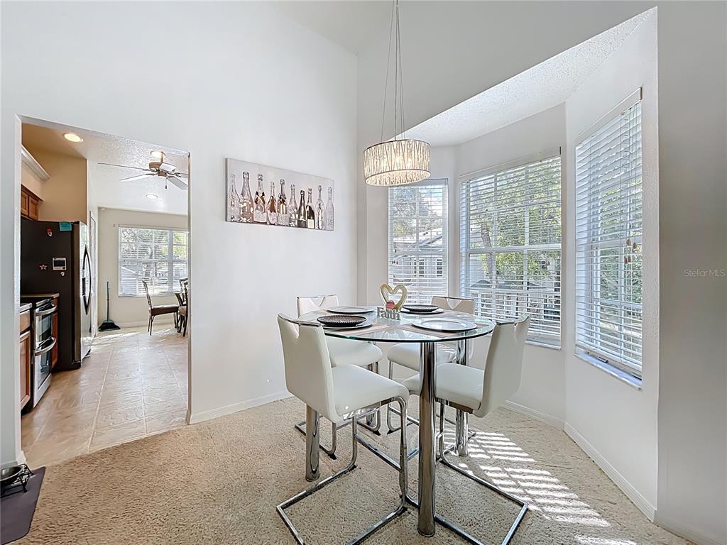 1050 Loch Vail, Unit 21 Apopka, FL 32712 - Photo 21 of 46 a view of a dining room with furniture window and wooden floor