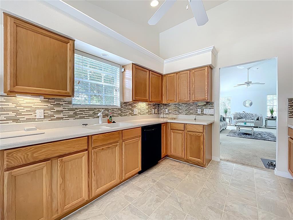 1050 Loch Vail, Unit 21 Apopka, FL 32712 - Photo 23 of 46 a kitchen with stainless steel appliances granite countertop a stove a sink and a microwave