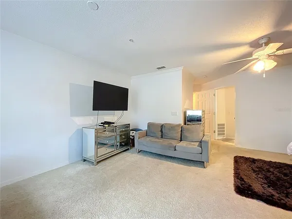 a bedroom with furniture and a large window