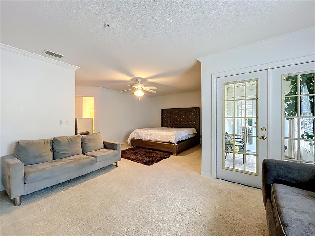 1050 Loch Vail, Unit 21 Apopka, FL 32712 - Photo 30 of 46 a bedroom with furniture and a large window