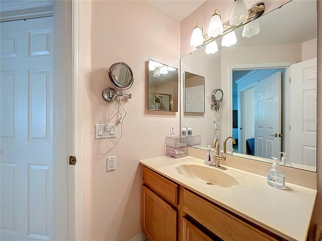 1050 Loch Vail, Unit 21 Apopka, FL 32712 - Photo 32 of 46 a bathroom with a sink vanity and a mirror