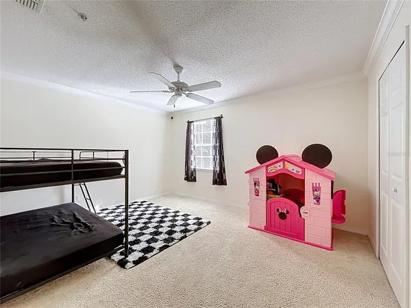 a bedroom with a bed and a lamp