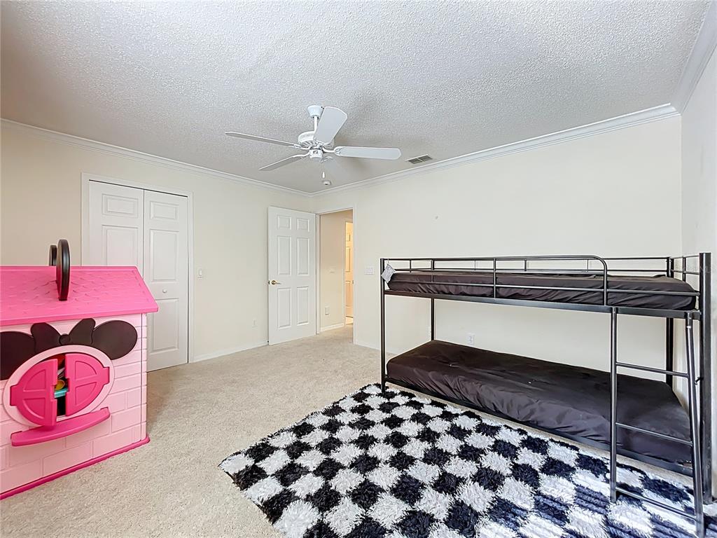 1050 Loch Vail, Unit 21 Apopka, FL 32712 - Photo 34 of 46 a bedroom with a bed and a lamp