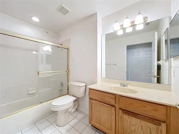 a bathroom with a sink a large mirror and vanity