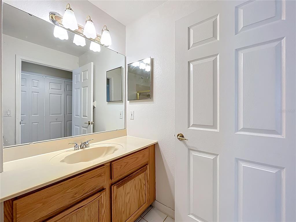 1050 Loch Vail, Unit 21 Apopka, FL 32712 - Photo 38 of 46 a bathroom with a sink a large mirror and vanity