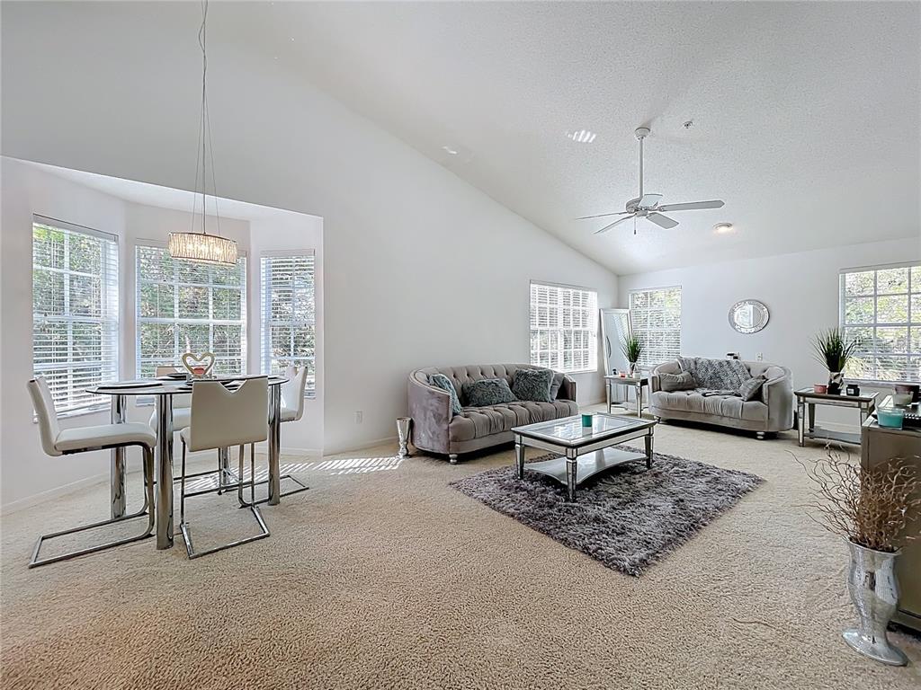 1050 Loch Vail, Unit 21 Apopka, FL 32712 - Photo 7 of 46 a living room with furniture and a large window