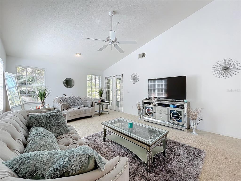 1050 Loch Vail, Unit 21 Apopka, FL 32712 - Photo 10 of 46 a living room with furniture and a flat screen tv
