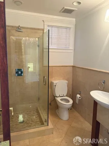 a bathroom with a toilet and a shower