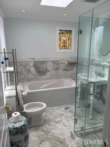 a bath room with a toilet and a shower