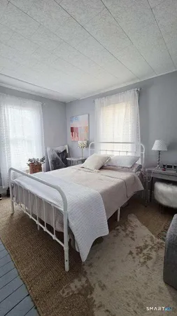 a bedroom with bed and a window