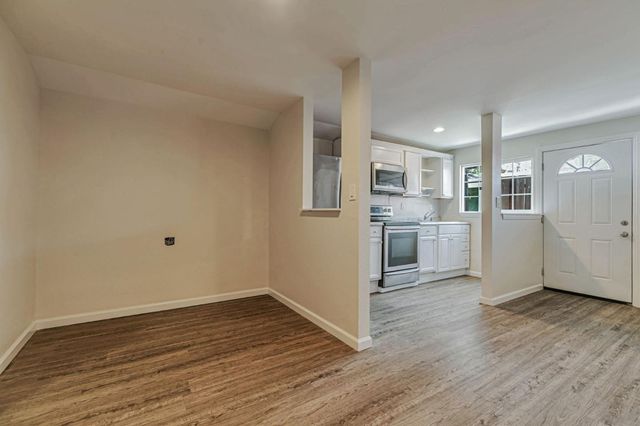 a kitchen with granite countertop stainless steel appliances a sink and cabinets