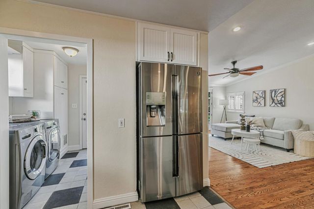 a kitchen with stainless steel appliances a refrigerator sink and microwave