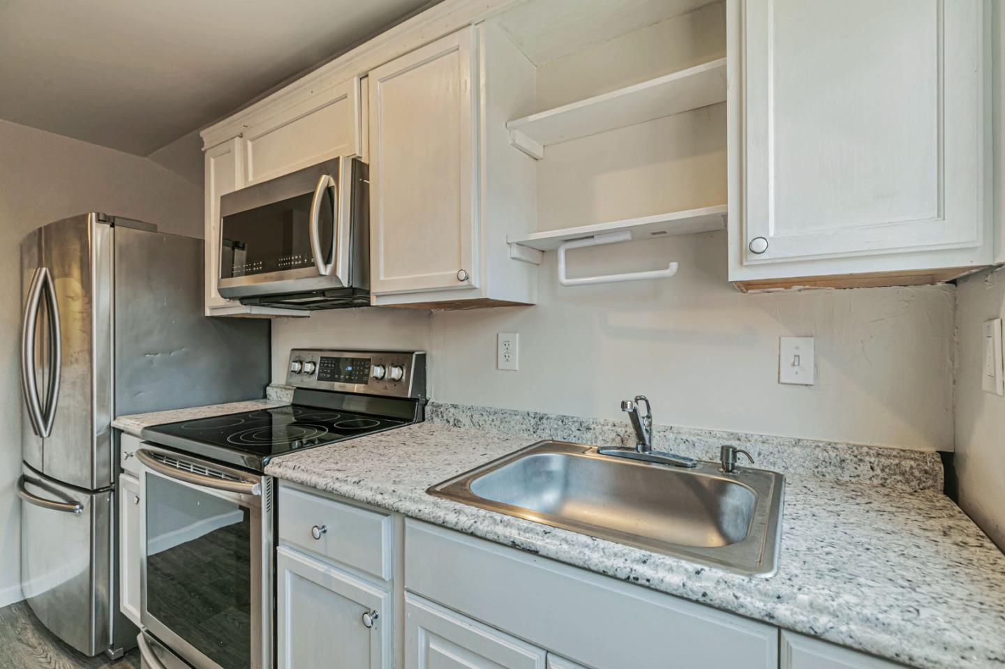 668 Curtner Avenue Campbell, CA 95008 - Photo 19 of 49 a kitchen with stainless steel appliances granite countertop a sink stove and microwave