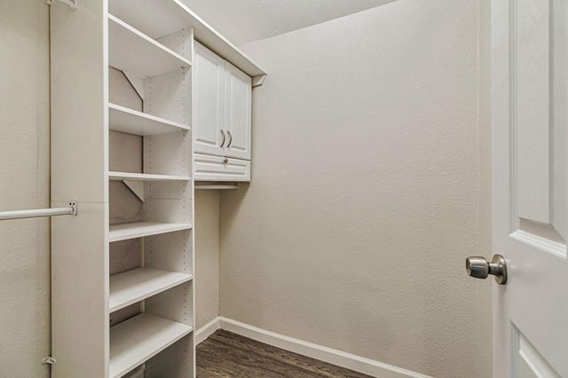a bathroom with a granite countertop sink mirror vanity and toilet