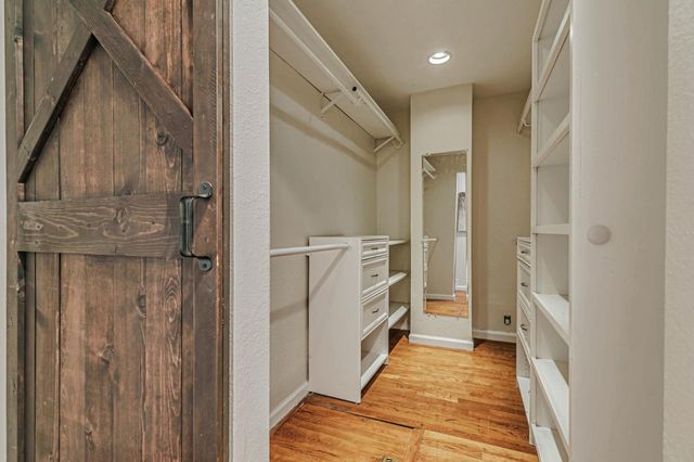 a bathroom with a granite countertop sink a toilet a large mirror and shower
