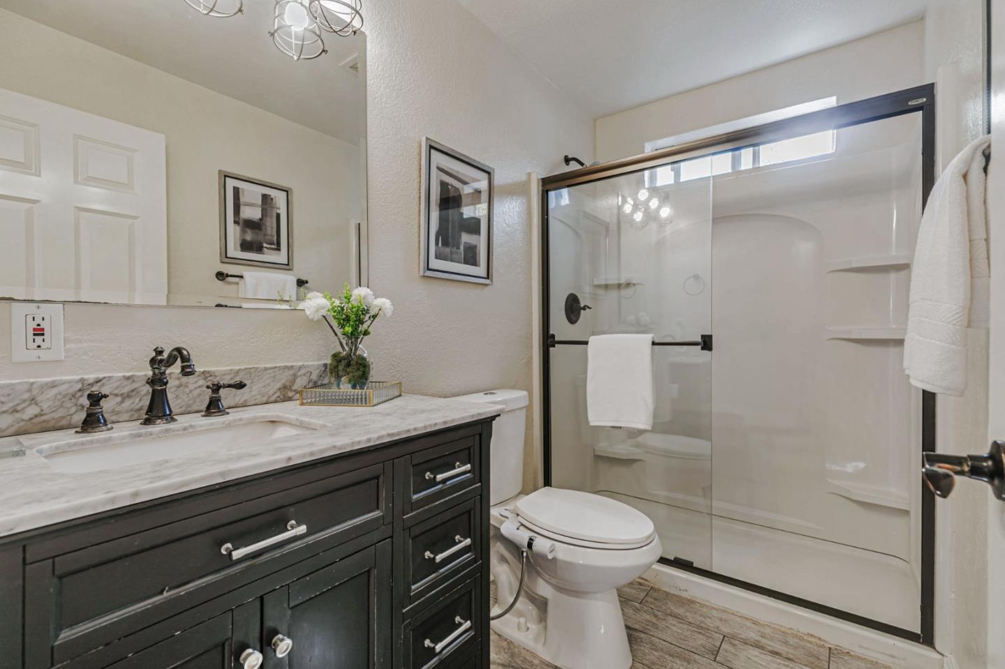 668 Curtner Avenue Campbell, CA 95008 - Photo 29 of 49 a bathroom with a granite countertop sink mirror vanity and toilet
